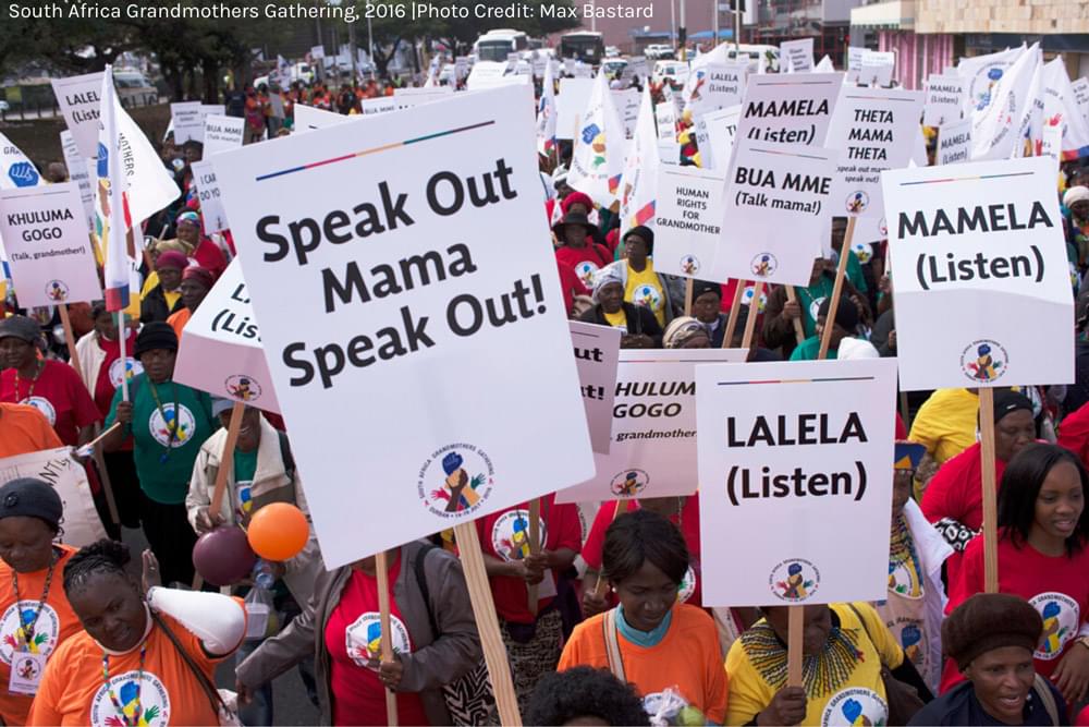 group of women marching with signs reading speak out mama speak out!