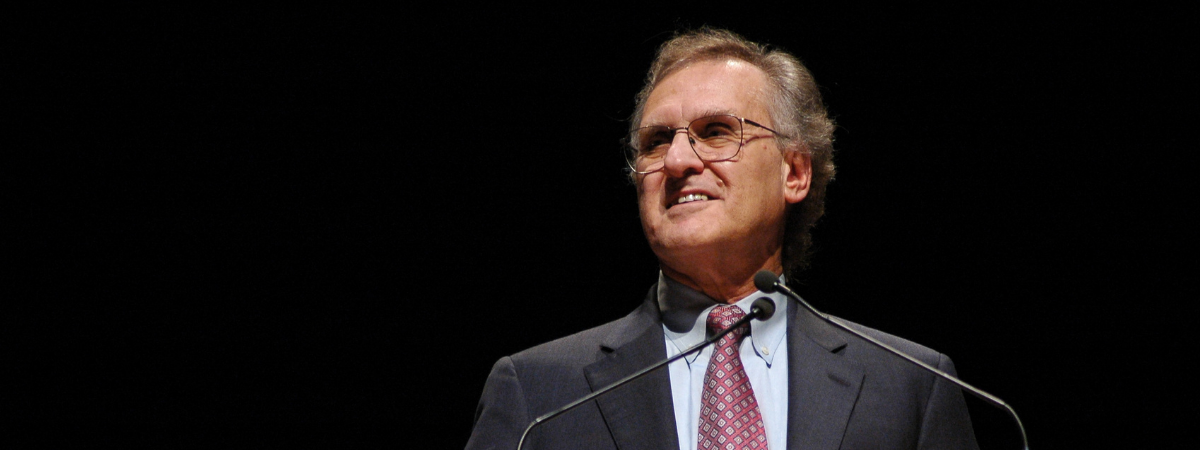 Stephen Lewis speaking at a podium at UBC.