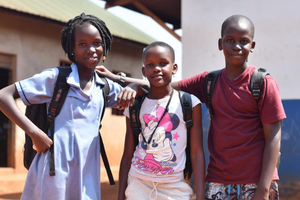 three students posing for a photo before going to school